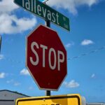 A stop sign with a street sign for Tallevast above and a no outlet sign below.