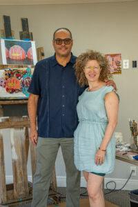 Photo of Javi Suarez with his arm around another person, facing the viewer.