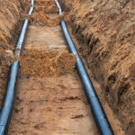 Photo of power cables running through a ditch.
