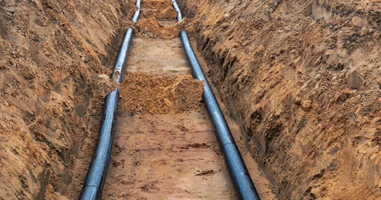Photo of power cables running through a ditch.