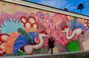 Annie Dong smiling in front of a mural