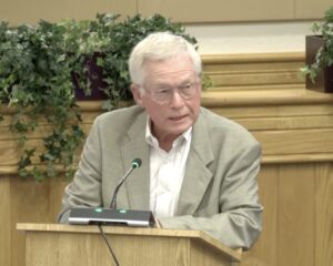 Mayor Ken Schneier speaking at a podium.