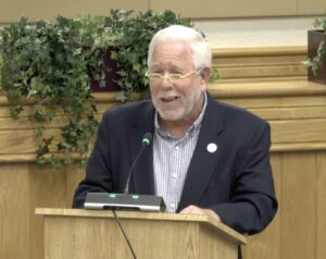Mayor Phil Stokes speaking at a podium.