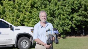 Wade Brennan speaking into microphones.