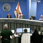 Commissioners George Kruse, Bob McCann, Amanda Ballard, and Jason Bearden in the Board of County Commissioners Chambers.