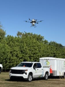 A drone hovering near a truck with Clarke branding.