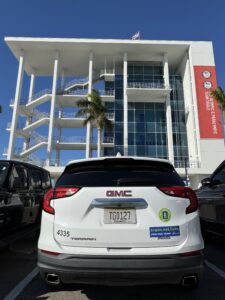 A car with a Sarasota County government bumper sticker parked outside the Benderson Finish Tower.
