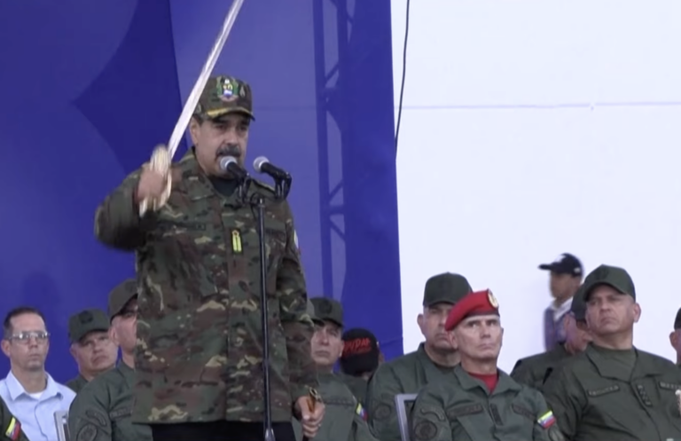 Maduro holds Bolívar's sword and addresses a crowd.