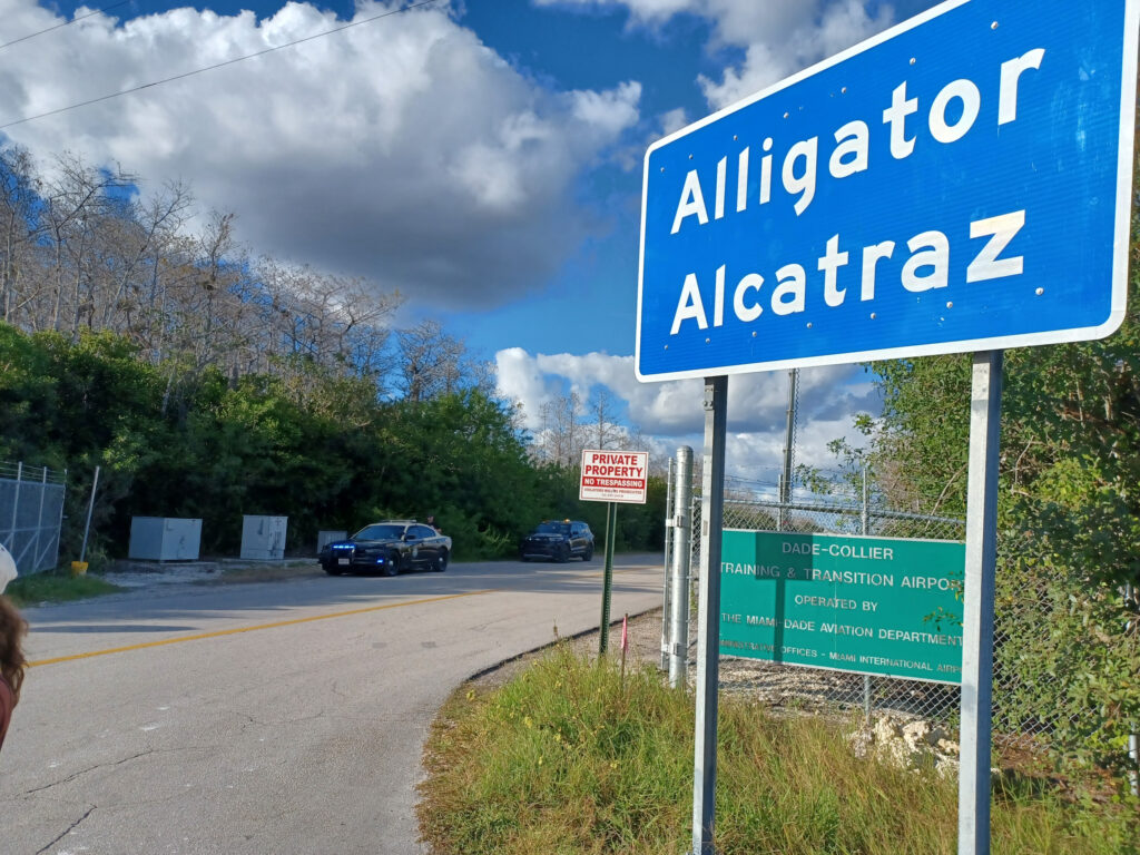 Road sign labelling the entry gate to Alligator Alcatraz.