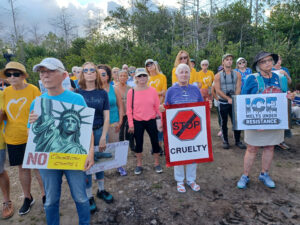 Demonstrators hold signs that read "No concentration camps", "Stop cruelty", and "ICE melts under resistance".