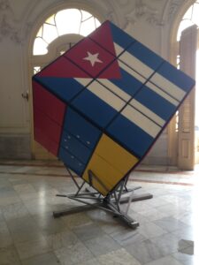 Sculpture of a giant Rubik's cube featuring the flags of Cuba and Venezuela.