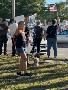 A demonstrator waving a bubble wand at an anti-ICE protest.