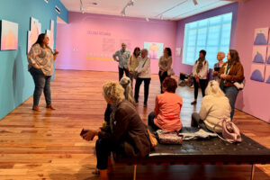 Selina Roman addressing a crowd at her "Abstract Corpulence" photo exhibition at Sarasota Art Museum,