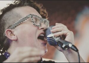 Close-up of Shannon Fortner singing passionately into a microphone.