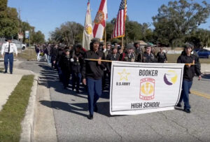 ROTC members carrying a Booker High School banner.