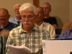 Victor Dobrin reads a stack of papers.