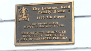City of Sarasota historical designation plaque titled "The Leonard Reid Family Home" describing it as "Constructed c.1926" and "Moved to this site in 1999.