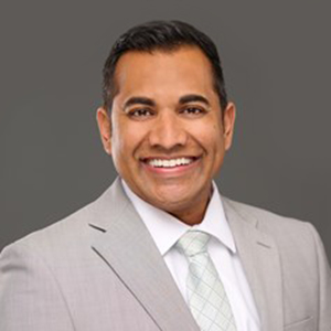 Nikesh Patel smiling.