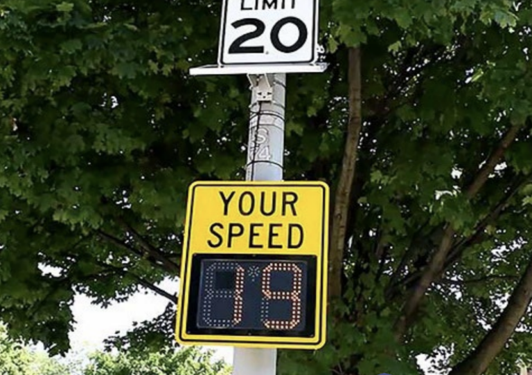 A 20 mph speed limit sign with a radar sign below.