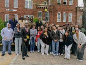 Students pose for a photo outside Tuskegee University's old administration building.