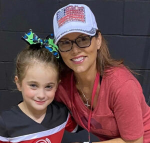 Teresa Dewitt and a young child smiling.