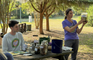 Tracie Troxler shows off the difference between labeled jars such as "Food Scraps," "Browns" and "Landfill".