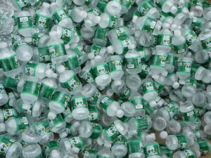 Countless Poland Spring water bottles in a cooler with chunks of ice.