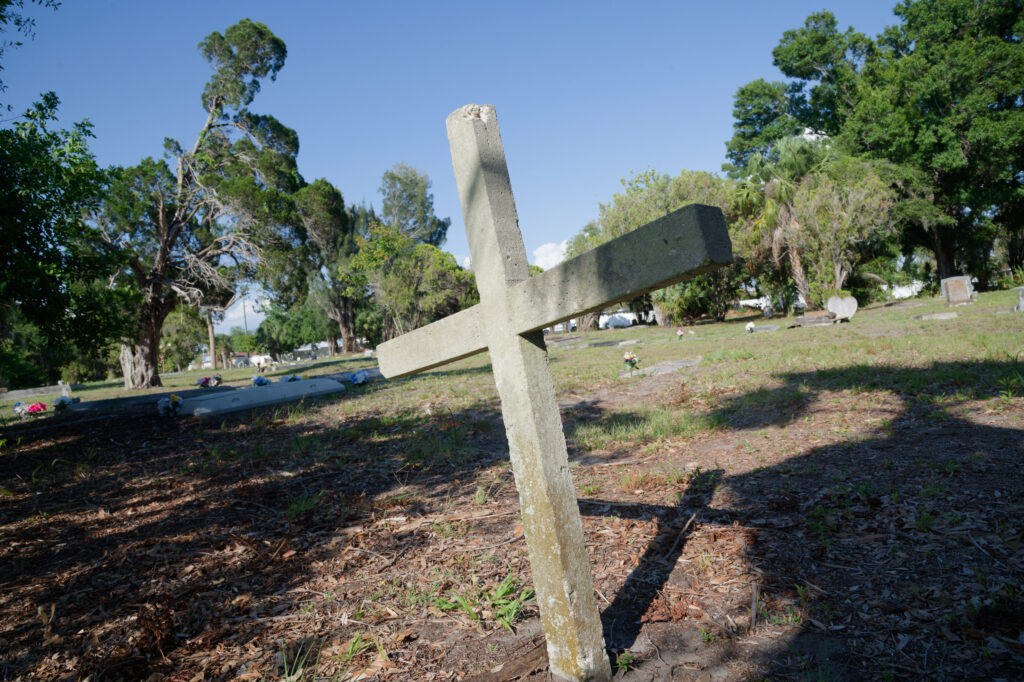 A cross-shaped marker in a cemetery.