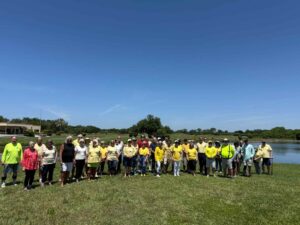 StayTRU members, many wearing yellow, lined up at Tatum Ridge Golf Links.