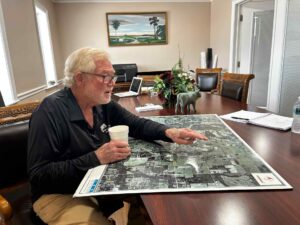 Eugene Turner gestures to a map.