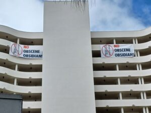 Banners hanging from the Bay Plaza condo that read "No obscene Obsidian!"