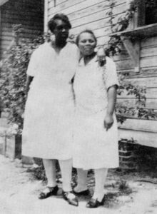 Black and white photo of Emma Booker with a friend.