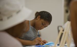 A person painting with a brush.