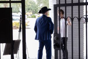 Eddie Speir from behind, standing in a doorway.