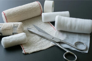 Rolls of gauze and a pair of scissors.
