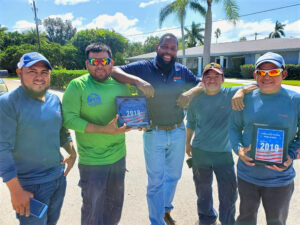 Five Longboat Key Roofing employees pose with "Best of 2019" awards.