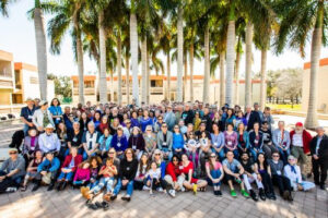 A large group photo outside New College.