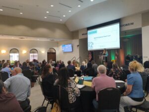 A crowd attends a presentation.