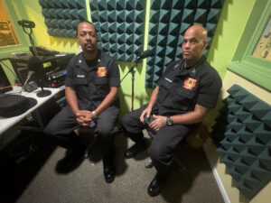 Justin Archer and Robert Sherman sitting in a recording studio.