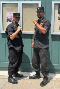 Robert Sherman and Justin Archer posing with raised fists.