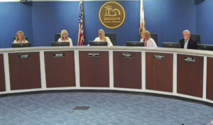 Liz Barker, Karen Rose, Bridget Ziegler, Robyn Marinelli and Tom Edwards in the Sarasota School Board meeting room.