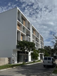 Street view of a high-end contemporary condo building.