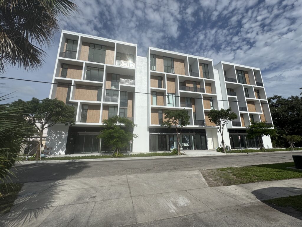 Street view of a high-end contemporary condo building.