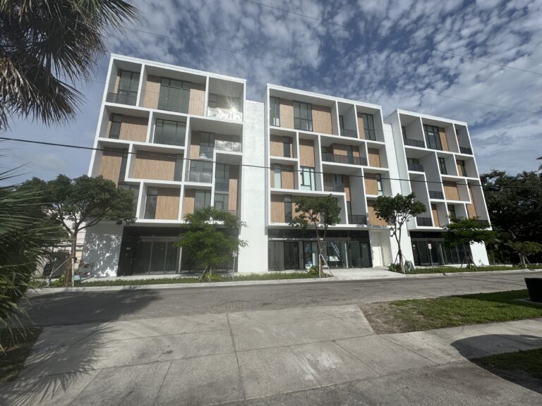 Street view of a high-end contemporary condo building.