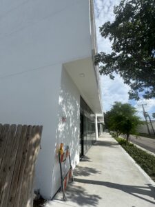 View of the sidewalk by a high-end contemporary condo building.