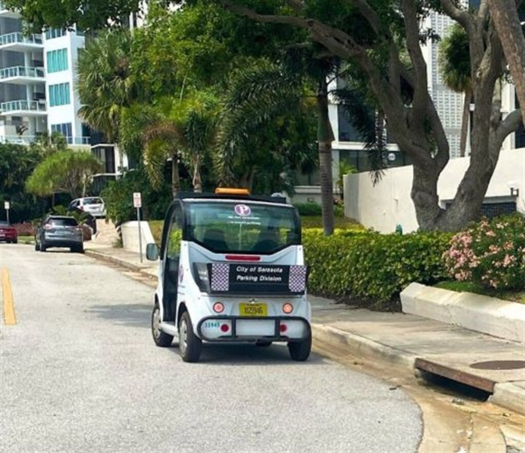 A City of Sarasota Parking Division vehicle parked on the side of the road.