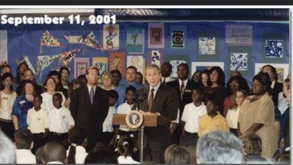George W. Bush standing at a podium and addressing a crowd. The photo is dated September 11 2001.