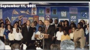 George W. Bush standing at a podium and addressing a crowd. The photo is dated September 11 2001.