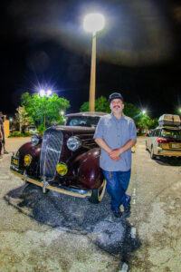 Danny de la Rosa posing in front of his 1936 Chevy.