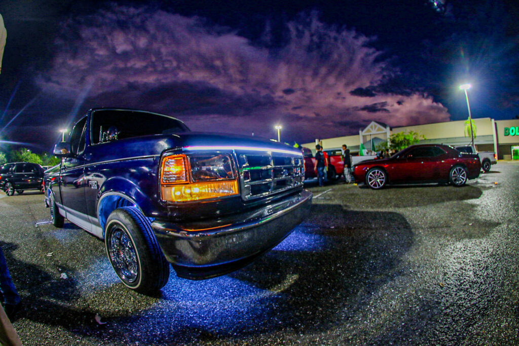 An F-150 with blue underglow lights.